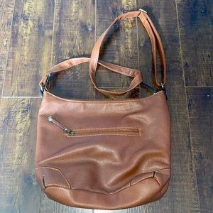 A denverhayes shoulder side purse. Used and has a fractured to the zipper tags.